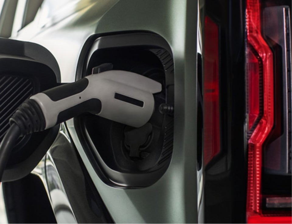 Close up of charging port with charger plugged in on a GMC Hummer EV SUV - Wilcoxson GMC in PUEBLO CO